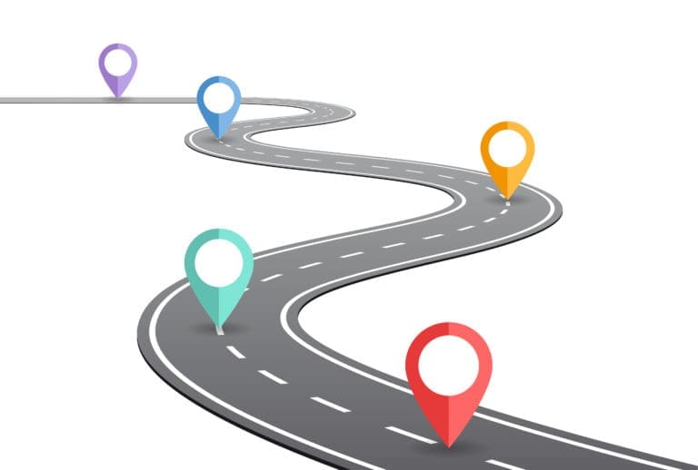 A road with pins on it leading to a destination.