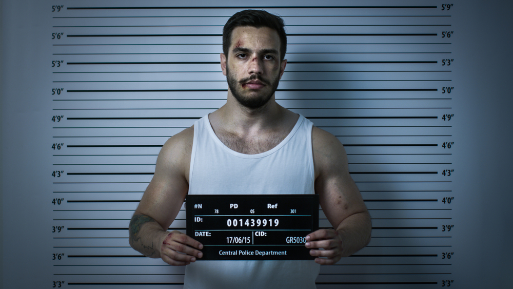 male in tank top mugshot