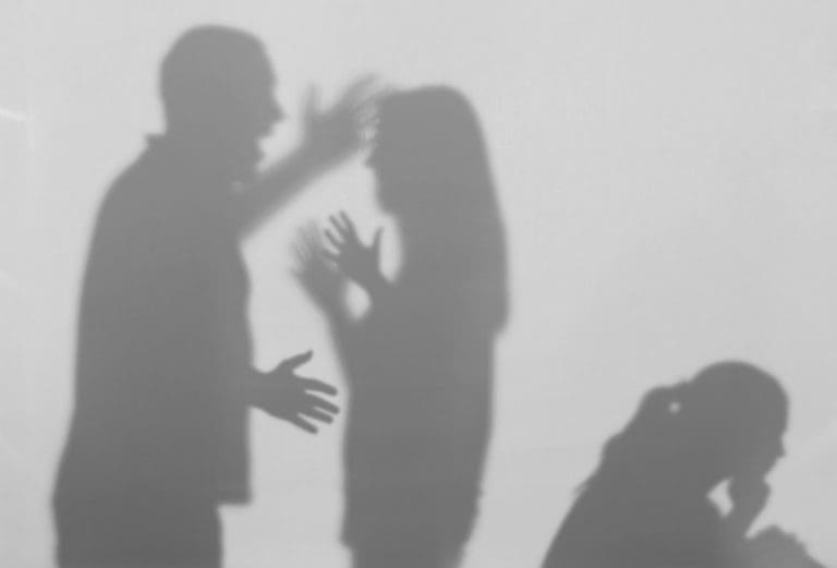 A shadow of a man and a woman talking to each other.