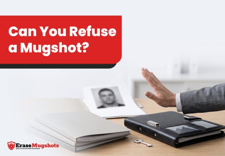 A person’s hand gestures “stop” near files, a photo of a face, a binder, and a key on a desk. The image features the text “Can You Refuse a Mugshot?”—highlighting the question of whether you can refuse a mugshot—and displays the Erase Mugshots logo.