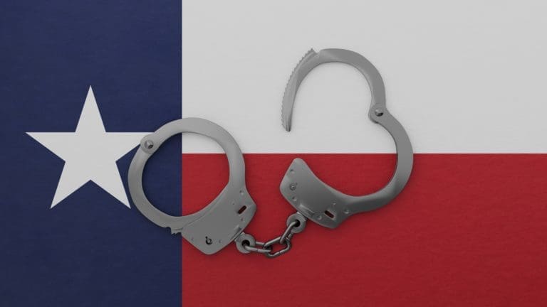 Handcuffs on a texas flag background.
